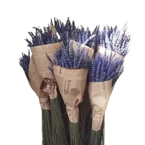 Natural dried lavender flower bouquet wrapped in vintage newspaper style for home decor.