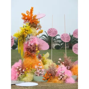Colorful hemp fiber filler and dried flowers for wedding gift box decoration and party setup.