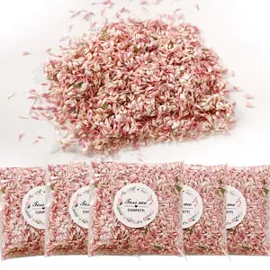 Detailed view of natural pink and white dry flower confetti petals in clear bags for parties.