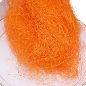 Orange raffia packing filler and shredded paper for gift box decoration and floral crafts display.
