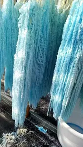 Close up detail of blue hanging preserved dried flowers for wedding and festival decoration.