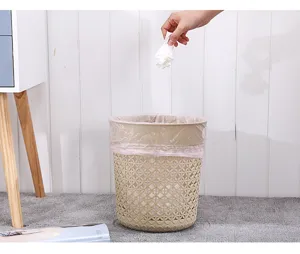Plastic hollow-out leaf trash can for bathroom and kitchen, lidless wastebasket detail view.