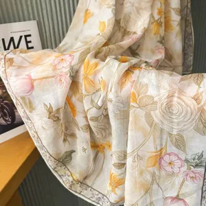 Close-up detail of a French retro floral silk-cotton scarf, showing soft draped texture.