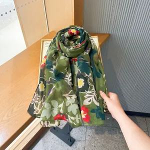 Detailed view of the elegant green floral printed silk scarf, perfect for summer travel.