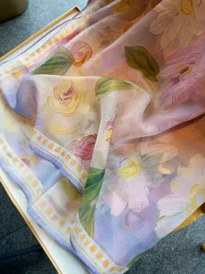 Detailed view showcasing the floral silk cotton scarf, delicate print texture and soft drape.