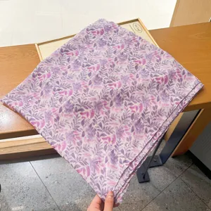Detailed shot of purple and pink leaf print sunscreen shawl, elegant scarf texture.