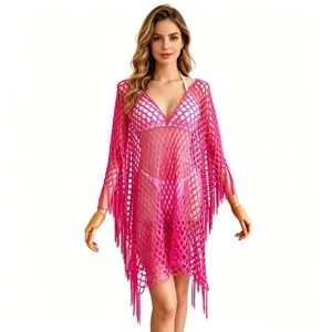 Pink crochet fringe beach cover-up detail, hollow mesh poncho design for summer vacation.