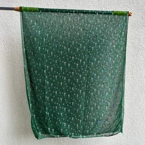 Green sequin sheer headscarf detail, lightweight gauze scarf fabric texture close-up display.