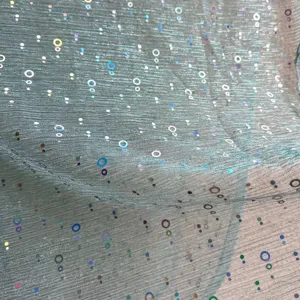 Close up detail shot of shiny holographic sequin pleated headscarf gauze fabric material.