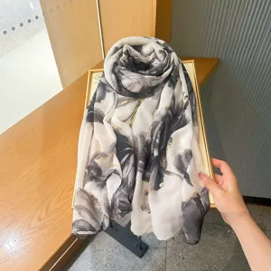 Elegant abstract floral print lightweight scarf with gold foil accents, perfect for summer sun protection.