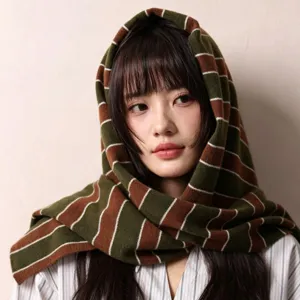 Detailed close-up of Australian wool striped knit shawl scarf worn by model, cozy winter texture.