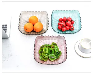 Vista dettagliata di piatti di frutta in plastica trasparente riempiti di snack.