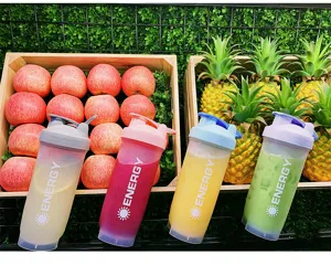 Portable fitness shaker cup for sports and protein shakes with scale and mixing ball details.