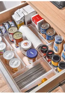 Clear plastic drawer organizer tray designed for kitchen cutlery and neat makeup storage.