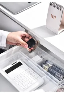 Transparent plastic drawer organizer detail showing clean multi-compartment desk storage.
