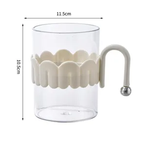 Transparent plastic mouthwash cup with scalloped sleeve and unique ball handle for bathroom.