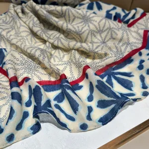 Close-up detail of women's printed long scarf featuring classic chain pattern and contrast border.