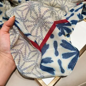 Women's long printed scarf with blue geometric circles and red border detail for autumn.