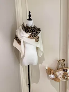 Detailed view of stylish leopard print shawl, lightweight luxury fashion accessory for women.