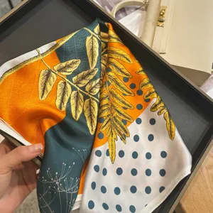 Detailed view of mulberry silk small square scarf with botanical leaf and dot pattern.