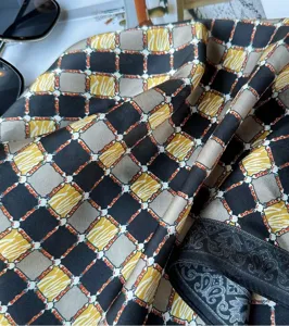Silk square scarf featuring elegant geometric chain pattern and stylish retro design for women.