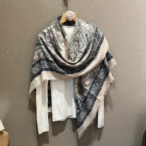 Detailed display of ethnic paisley print large square scarf showing soft fabric drape.