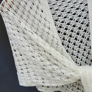 White sequin knit shawl detail close-up, summer lightweight sun protection neck wrap.