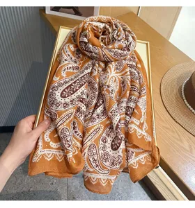 French vintage paisley scarf detail, elegant orange silk-like neckerchief for women fashion.