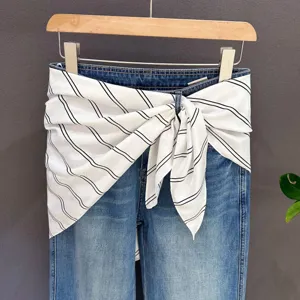 Denim jeans with trendy black white striped waist scarf layered accessory for women style.