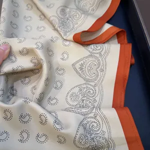 Elegant women's paisley silk scarf with contrast orange edge, versatile autumn neckerchief.