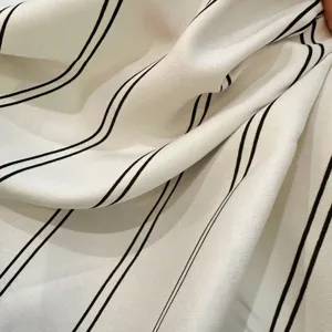 Fashion black and white striped triangle scarf, elegant fabric layering accessory for daily wear.