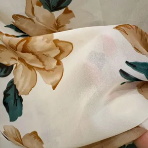 Close-up detail of lightweight floral fabric showing sheer texture and elegant botanical print.