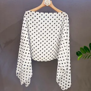 Detailed close-up view of the elegant black and white polka dot chiffon shawl design.