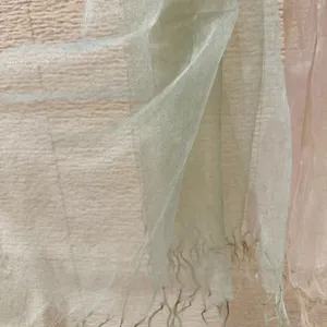 Detail view of the lightweight mesh fringe scarf texture, soft translucent sheer fabric close-up.
