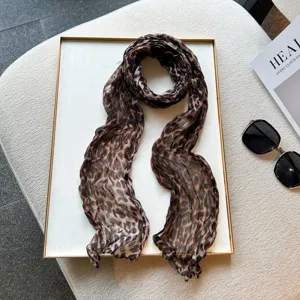 Leopard print pleated detail view showing the soft texture and crinkled design of the chic long scarf.
