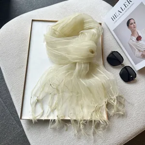 Detail view of lightweight sheer organza fringe scarf with striped texture for spring summer.