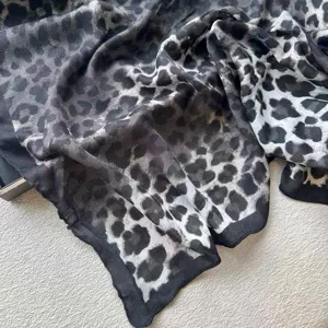 Detailed view of a stylish black and grey leopard print cotton linen shawl scarf for women.