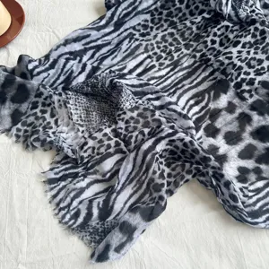 Detailed view of vintage leopard and zebra print pleated thin silk scarf texture and drape.