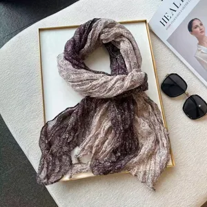 Detail shot of women's autumn pleated cotton linen scarf with elegant paisley pattern.