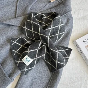Detailed shot of winter cross knitted scarf in dark grey with elegant diamond pattern warm.