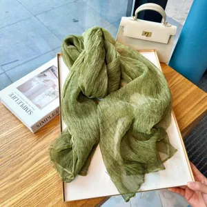 Solid green crinkled nylon slub scarf, lightweight breathable neck wrap for autumn styling.