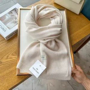 Cozy beige knitted scarf for women and men, classic winter warm neck wrap fashion item.