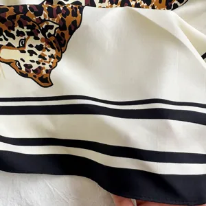 Retro leopard print silk triangular scarf detail, vintage old money style fashion accessory.