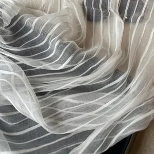Lightweight white sheer striped fabric detail, soft draped texture close-up for summer wear.