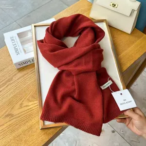 Red knit wool scarf winter warm neckwear detail closeup view for cold weather daily style.