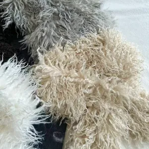 Close-up detail of fluffy faux shearling curly fur scarf material, soft and warm winter texture.