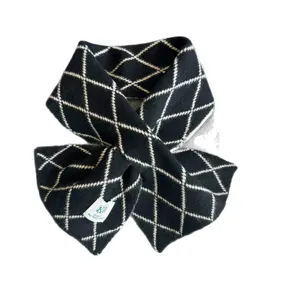 Classic black and white argyle knitted cross scarf, warm and stylish winter accessory.