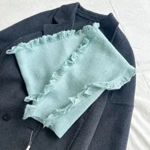 Cozy light blue knit scarf featuring charming frilled lace edges for autumn winter fashion.