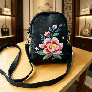 Black floral embroidered crossbody bag for women, ethnic style casual shoulder handbag with strap.