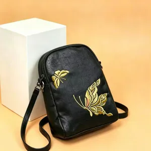 Black crossbody shoulder bag featuring elegant gold embroidered butterfly details and zip closure.
